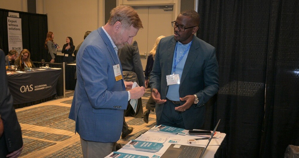 An attendee engaging with a representative at exhibit hall