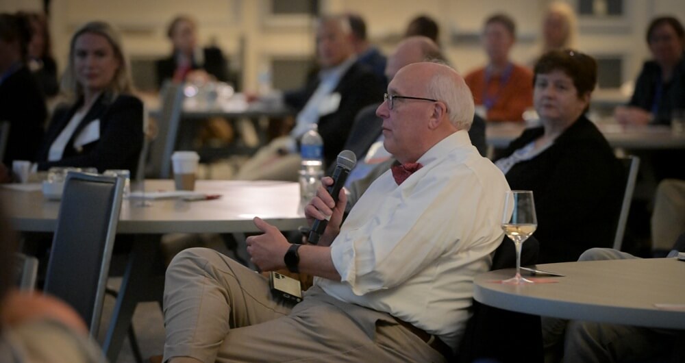 Attendee asking a question in a session