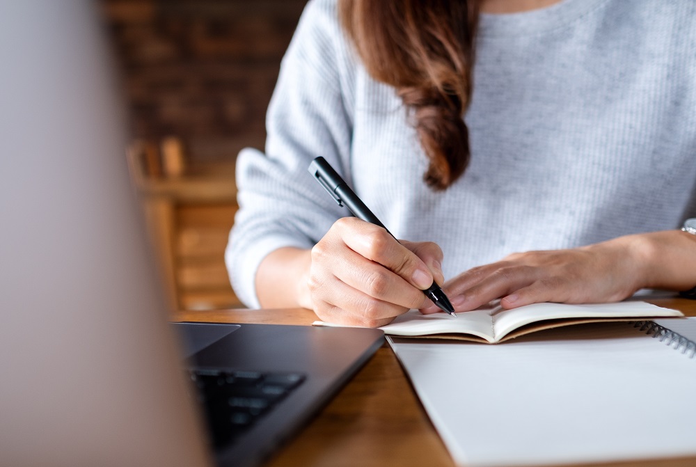 Person researching and taking notes