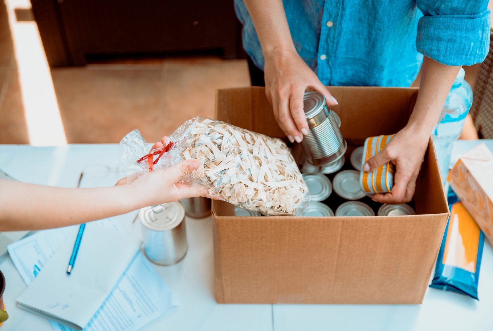 Packing food cans and items in a box
