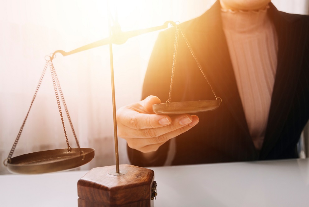 Woman holding the other side of a justice scale