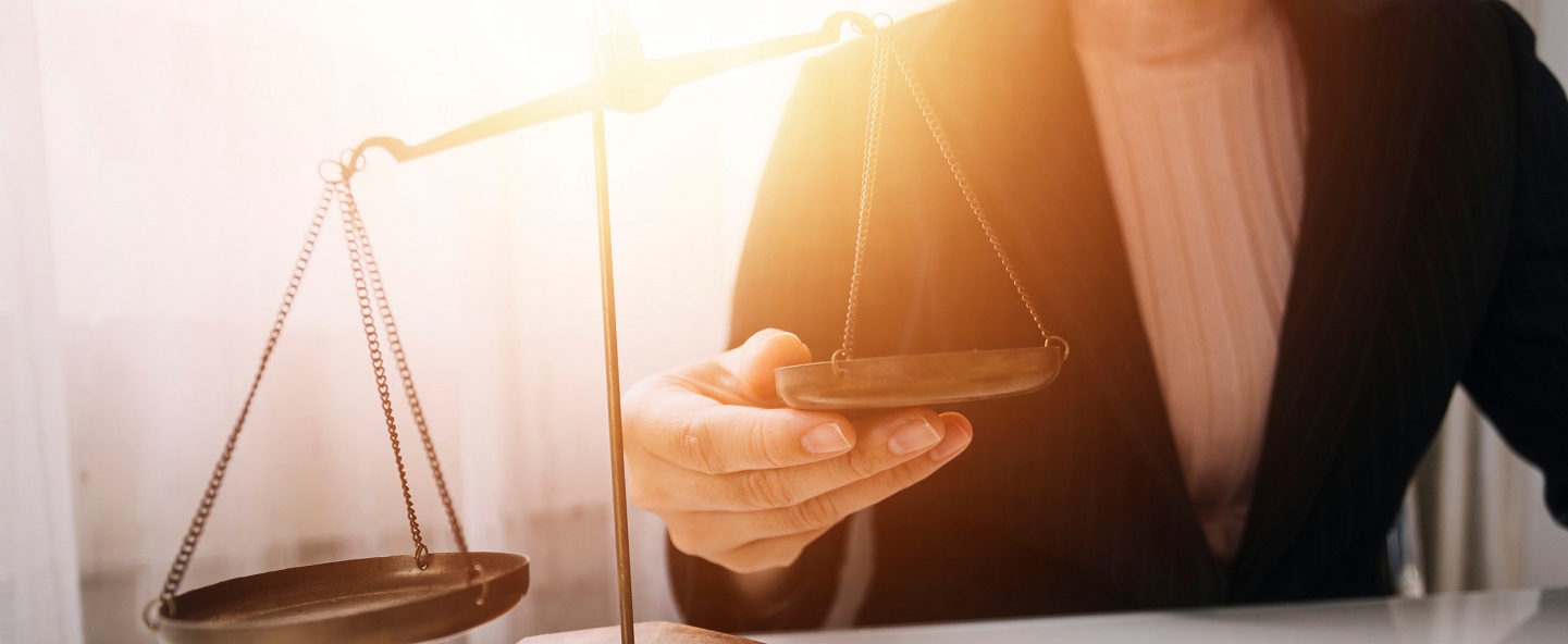 Woman holding the other side of a justice scale