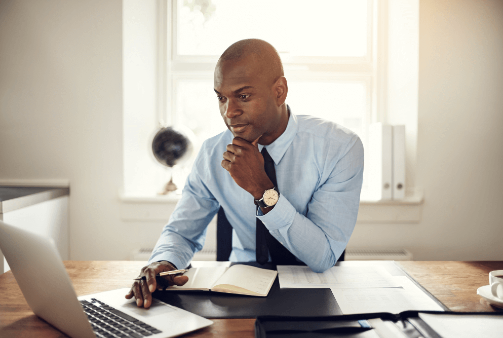 Man working with laptop and thinking in a room