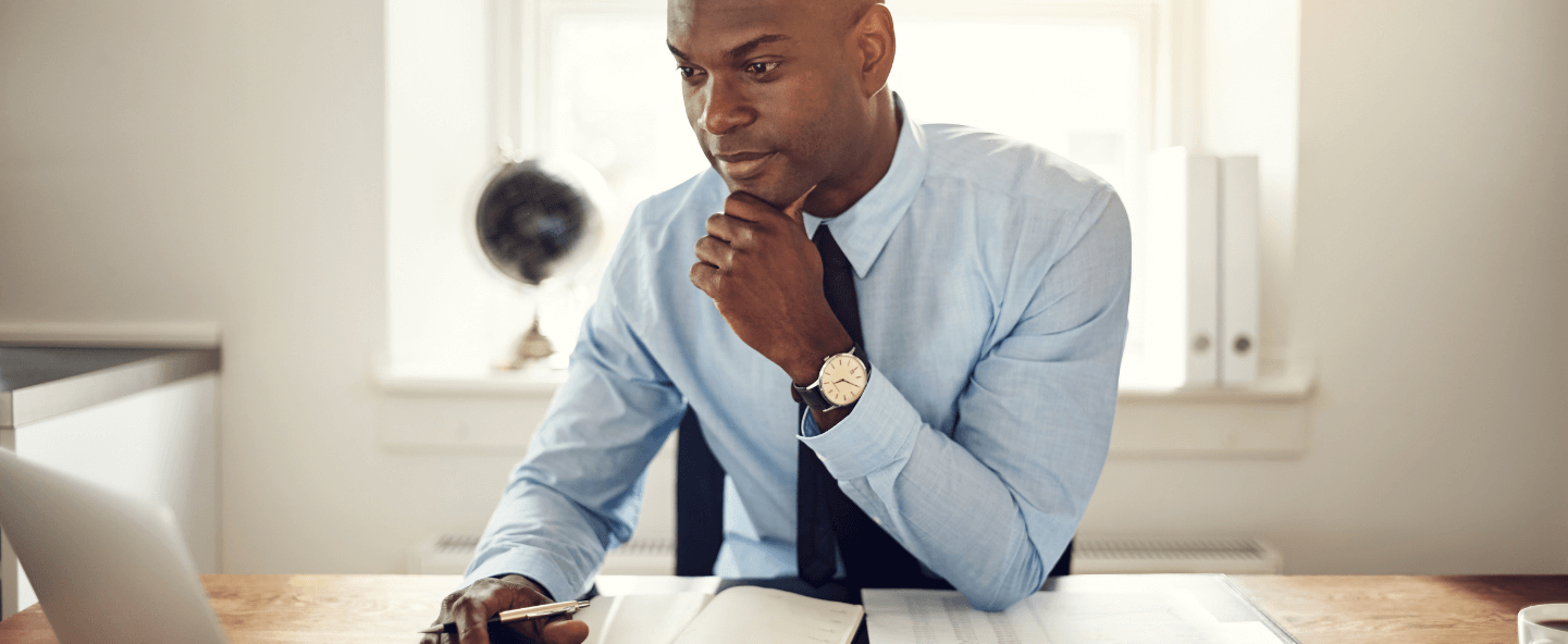 Man working with laptop and thinking in a room