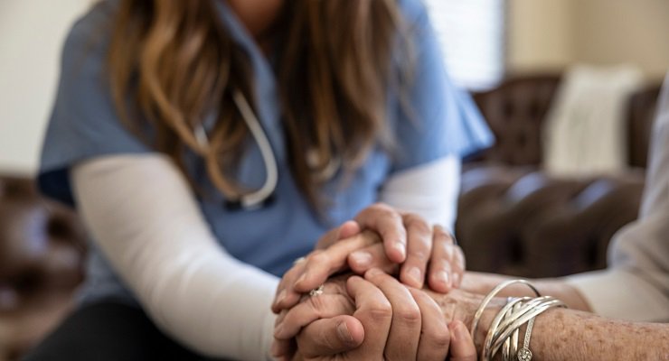 Caregiver holding elderly's hand