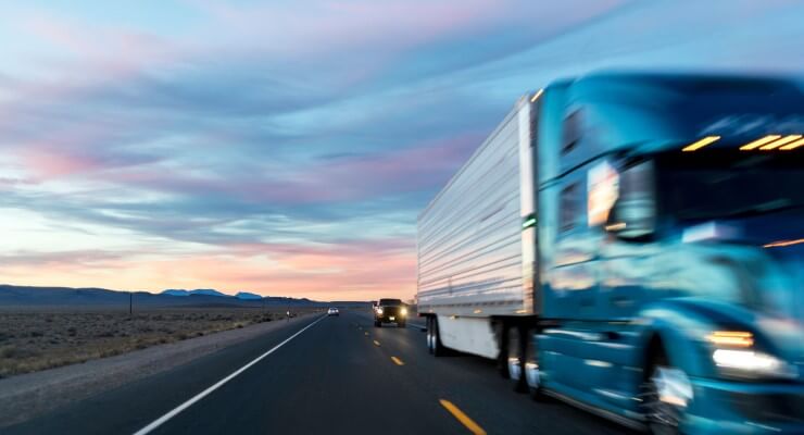 Truck on a highway during sunrise